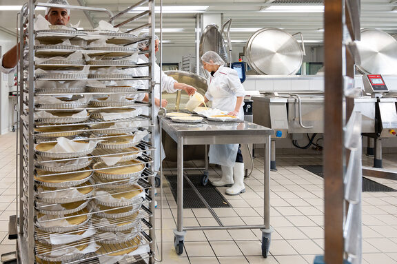 Vue d'une cuisine professionnelle, tartes sur plateaux dans un charriot